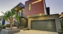 Custom modern home at dusk with lights on